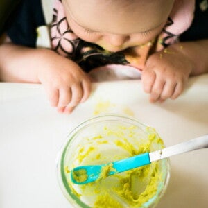 Un bambino mentre mangia le sue prime pappe